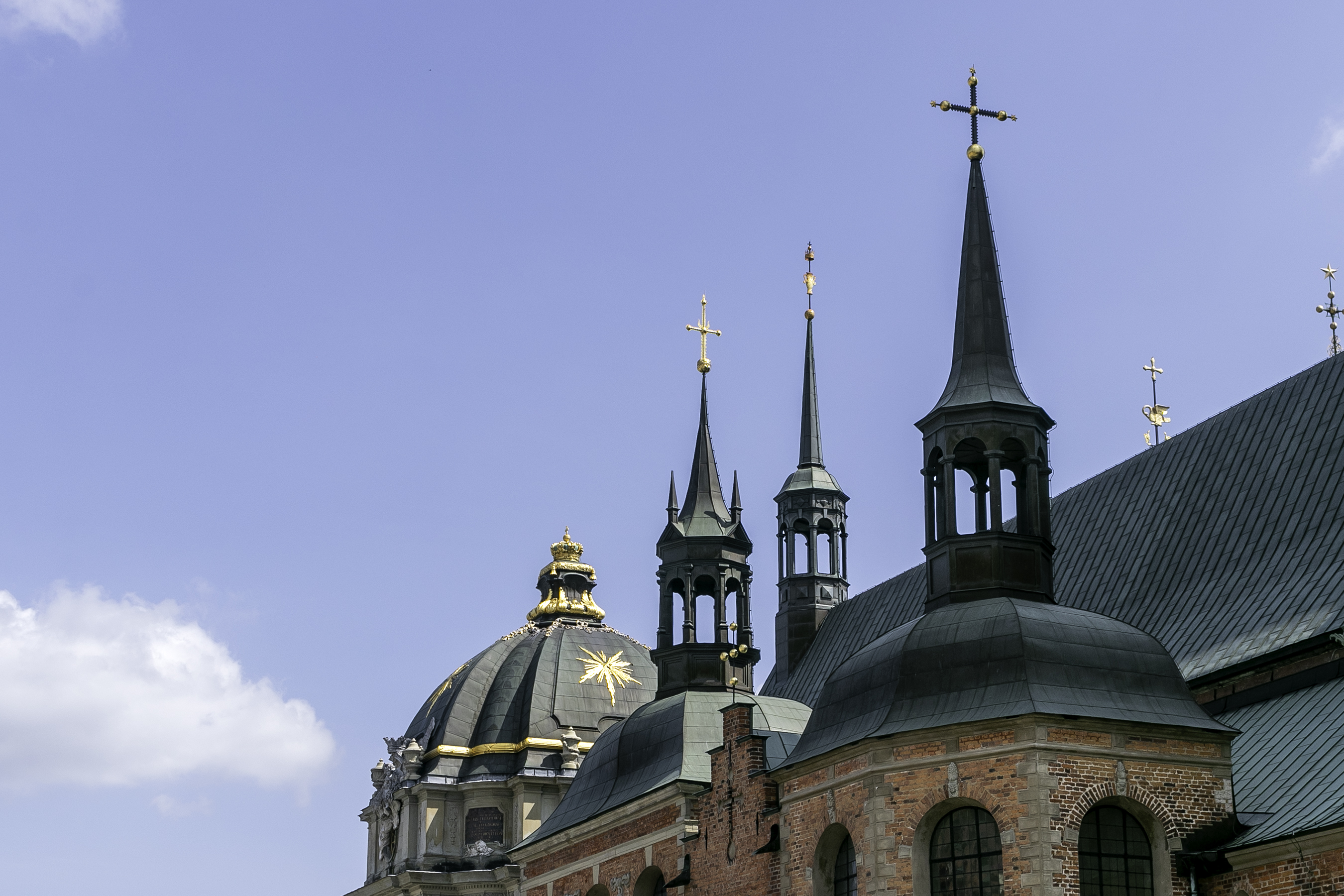 The openwork cast-iron latticework spire of Riddarholmen Church rising into the sky, like black lace.
